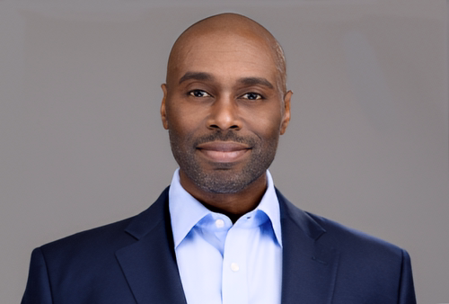 Headshot of a male on a medium gray background Headshot of a male on a medium gray background